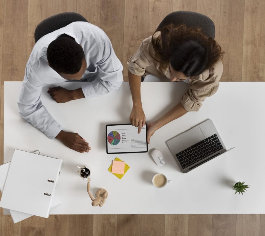 top-view-colleagues-working-desk (1)